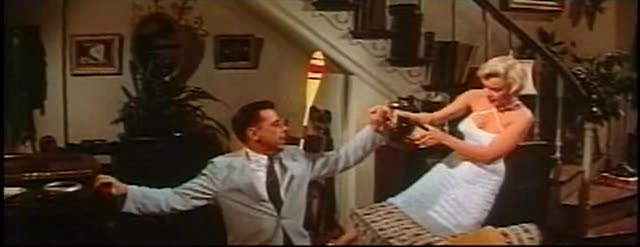 Monroe and Ewell open a bottle in The Seven Year Itch trailer 1.jpg